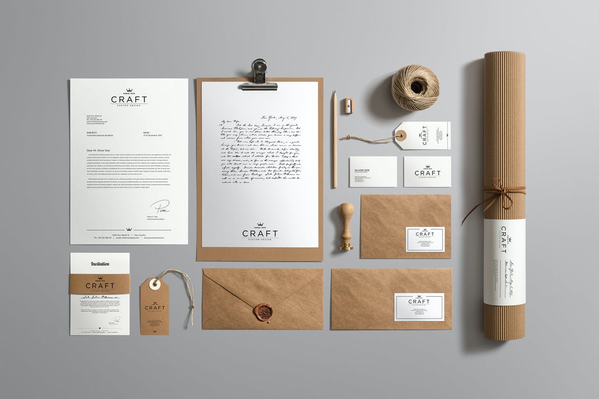 Letterhead, hang tag, business cards, envelopes, and shipping labels laid out flat on a table displaying cohesive branding suite options